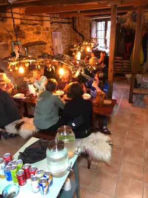 a group of people sitting at tables in a room at Casa Cantadora in Ambasmestas