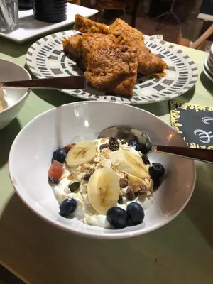 a bowl of food with fruit and blueberries on a table at Casa Cantadora in Ambasmestas