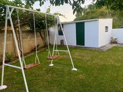 a swing set in the yard of a house at Casa Lupe, retiro rural cerca de A Coruña in A Coruña