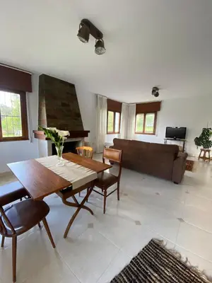 a living room with a table and a couch at Casa Lupe, retiro rural cerca de A Coruña in A Coruña