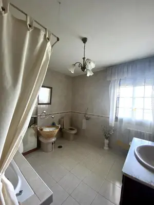 a bathroom with two toilets and a sink at Maison familiale avec vue in Puente-Castrelo