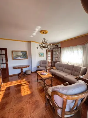 a living room with a couch and a table at Maison familiale avec vue in Puente-Castrelo