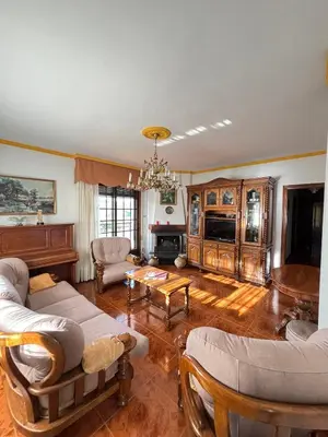 a living room with couches and a table at Maison familiale avec vue in Puente-Castrelo