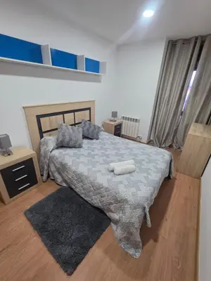 a bedroom with a bed and a window at Casa de sney in Sarria