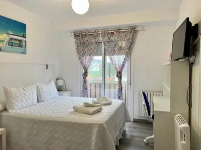 a bedroom with a large bed with a window at El Marquesado de Santiago en Milladoiro in Milladoiro