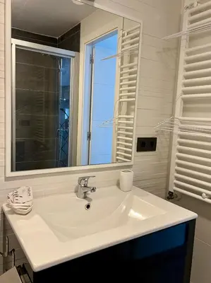 a bathroom with a white sink and a mirror at El Marquesado de Santiago en Milladoiro in Milladoiro