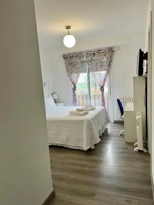 a bedroom with a bed and a window at El Marquesado de Santiago en Milladoiro in Milladoiro