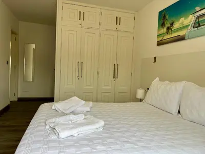 a bedroom with a white bed with towels on it at El Marquesado de Santiago en Milladoiro in Milladoiro