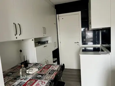 a small kitchen with a table with a table cloth on it at El Marquesado de Santiago en Milladoiro in Milladoiro