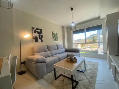 a living room with a couch and a table at Adeline in Caldas de Reis