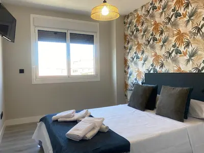 a bedroom with a bed with two towels on it at Adeline in Caldas de Reis
