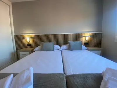 a bedroom with two beds and a couch at Adeline in Caldas de Reis