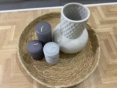 a bowl with vases and candles on a table at Adeline in Caldas de Reis