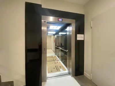 an elevator with a glass door in a building at Adeline in Caldas de Reis