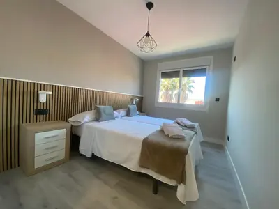 a bedroom with a large bed and a window at Adeline in Caldas de Reis