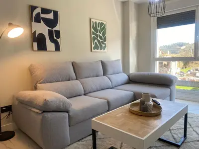 a living room with a couch and a coffee table at Adeline in Caldas de Reis