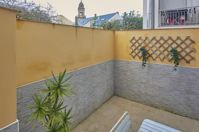 a balcony with a fence and some plants at Apartamento Porto Foz in Foz