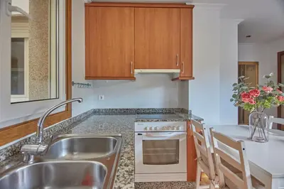 a kitchen with a sink and a stove at Apartamento Porto Foz in Foz