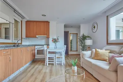 a kitchen and living room with a couch and a table at Apartamento Porto Foz in Foz