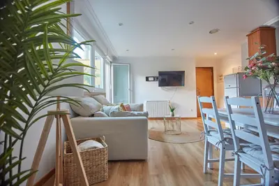 a living room with a couch and some chairs at Apartamento Porto Foz in Foz