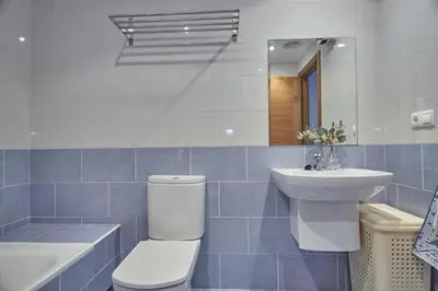 a bathroom with a toilet and a sink and a mirror at Apartamento Porto Foz in Foz