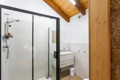a bathroom with a shower and a sink at Casa Vacacional Retiro Rural en el Camino The Land of Eve in Friol