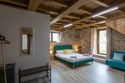a bedroom with a bed and a blue couch at Casa Vacacional Retiro Rural en el Camino The Land of Eve in Friol