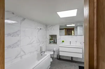 a bathroom with a tub and a toilet and a sink at Casa Vacacional Retiro Rural en el Camino The Land of Eve in Friol