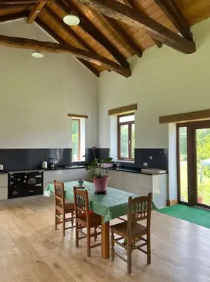 a kitchen with a table and chairs in a room at Casa Vacacional Retiro Rural en el Camino The Land of Eve in Friol