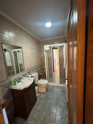 a bathroom with a toilet and a sink at Apartamentos Helenias in Boal
