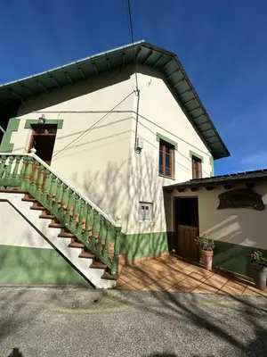 a house with a staircase on the side of it at Apartamentos Helenias in Boal