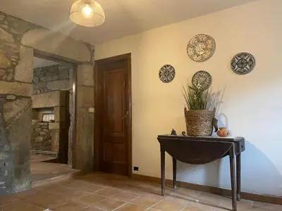 a room with a table and plates on the wall at Rincón rural in Tomonde
