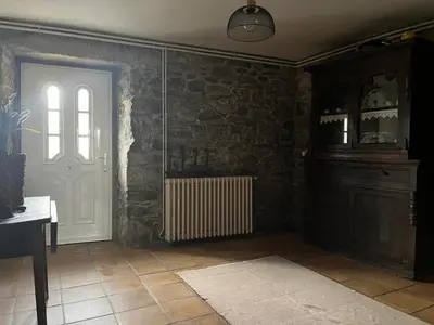 a room with a white door and a window and a table at Rincón rural in Tomonde