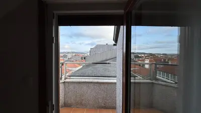 an open window with a view of a city at A Cuarta Ronda II in Melide