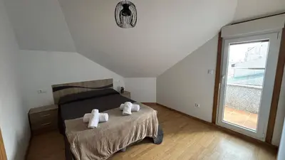 a bedroom with a bed with two towels on it at A Cuarta Ronda II in Melide