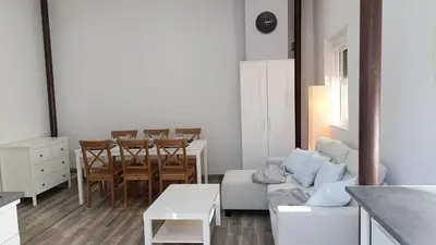 a living room with a couch and a table and chairs at Tu Escapada a Coruña in Guísamo