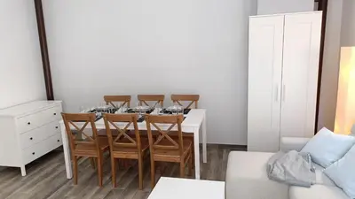 a dining room with a table and four chairs at Tu Escapada a Coruña in Guísamo