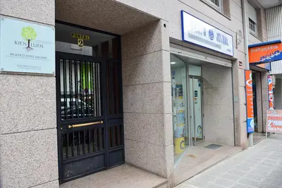 an entrance to a building with a black door at Cruxa Apartments garaje incluido in Santiago de Compostela