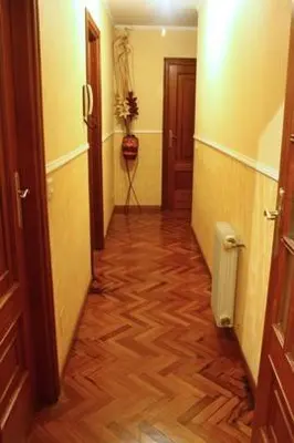 a hallway with a wooden floor in a room at Cruxa Apartments garaje incluido in Santiago de Compostela