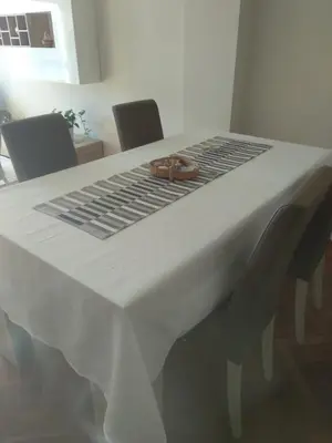 a white table with a rope on top of it at Apartamento luminoso con vistas a la ría in Cambre