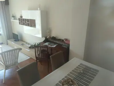 a kitchen and dining room with a table and chairs at Apartamento luminoso con vistas a la ría in Cambre