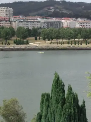 a view of a lake with buildings in the background at Apartamento luminoso con vistas a la ría in Cambre