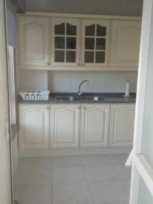 a kitchen with white cabinets and a sink at Apartamento luminoso con vistas a la ría in Cambre