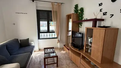 a living room with a couch and a tv at apartamento TAHOCES 1 VUT-LE-1369 in Ponferrada
