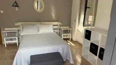 a bedroom with a white bed and a mirror at apartamento TAHOCES 1 VUT-LE-1369 in Ponferrada
