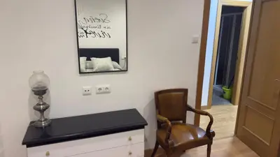 a room with a chair and a table and a mirror at apartamento TAHOCES 1 VUT-LE-1369 in Ponferrada
