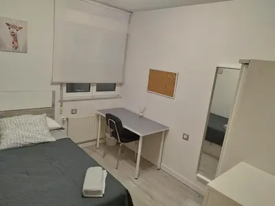 a bedroom with a desk and a bed and a table at Montirón 113 - Fontiñas in Lugo