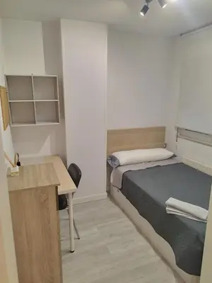 a small bedroom with a bed and a desk at Montirón 113 - Fontiñas in Lugo