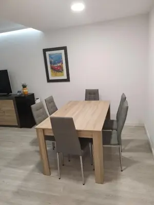 a wooden dining room table and chairs in a room at Montirón 113 - Fontiñas in Lugo