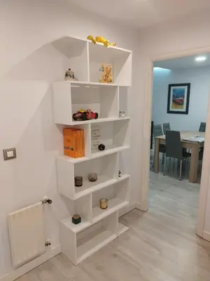 a living room with white shelves on the wall at Montirón 113 - Fontiñas in Lugo